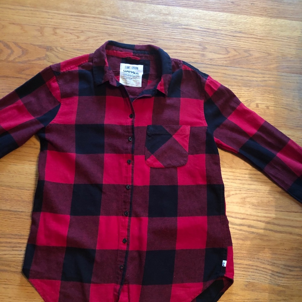 Woman’s red flannel button down shirt .